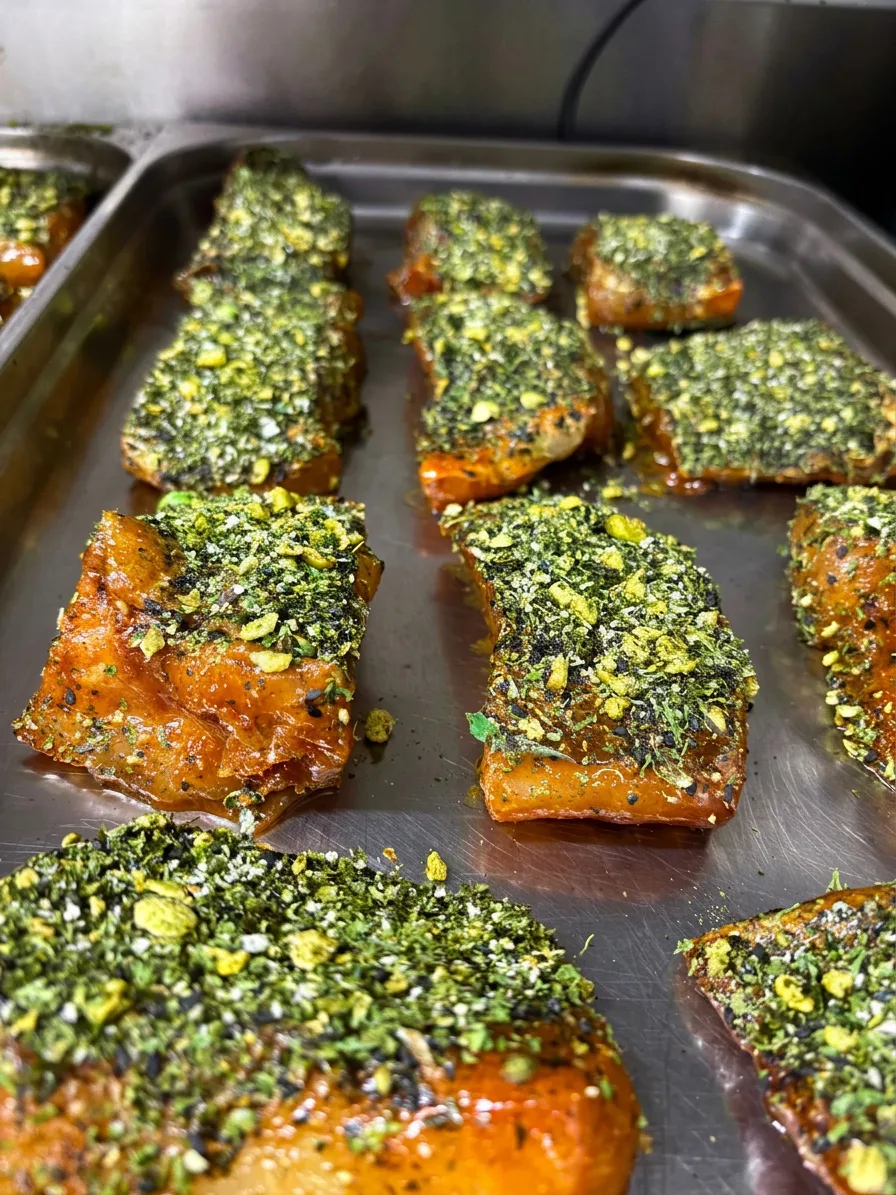 Herb-crusted salmon fillets ready for service