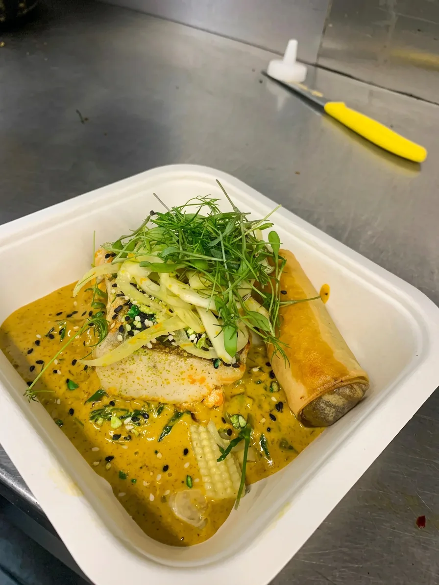 Thai curry with spring roll and fresh herbs